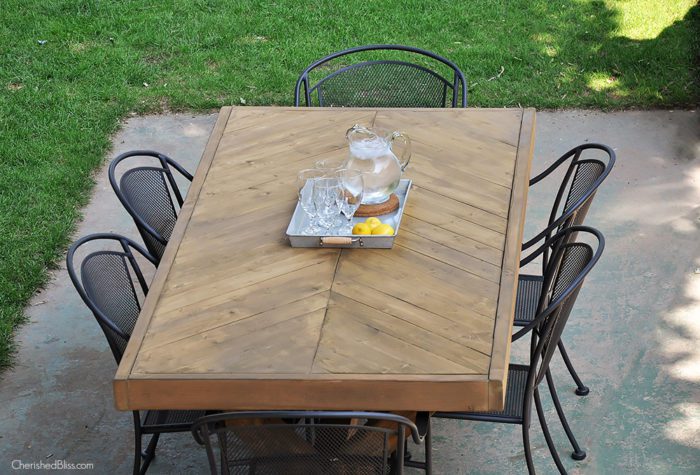 Build this DIY Outdoor Table featuring a Herringbone Top and X Brace Legs! Would also make a great Rustic Dining Room Table!