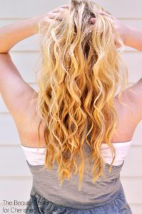 Learn how to get beach waves with this speedy alternative for the hot summer hair trend by using a curling wand/iron and DIY beach spray.