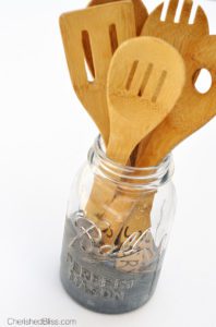 Add a little character to your kitchen with this DIY Mason Jar Utensil Holder with a "dipped" chalkboard accent!