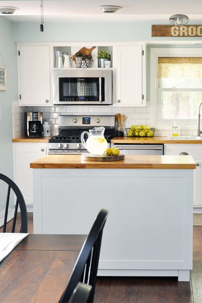 This industrial farmhouse kitchen is both functional and inviting. Stainless steel appliances bring a professional industrial look while adding softer elements provides the comfort of a farmhouse.