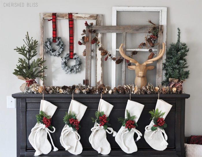 Super Cozy Christmas Mantel with drop cloth stockings, mini wreaths, pine cones, and a deer head! 