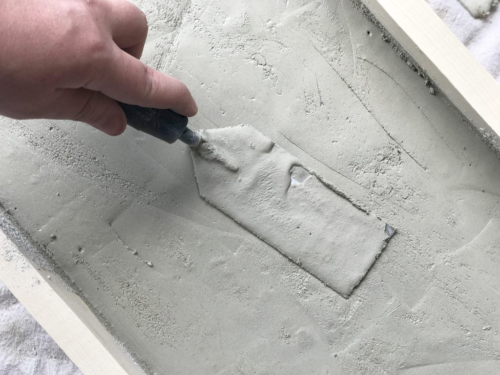 Learn how to create this gorgeous DIY Concrete Tray & some tips for working with concrete. Create different shapes and customize with handles!