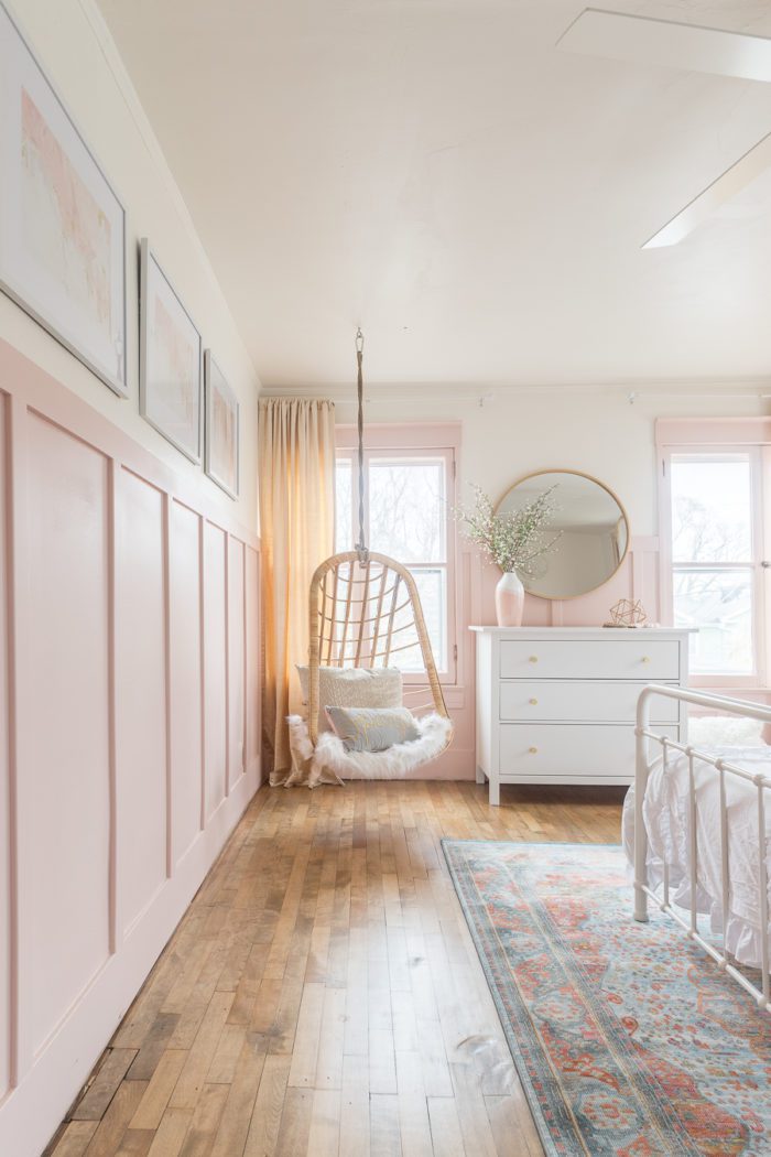 hanging wicker chair in pink and gold girls bedroom
