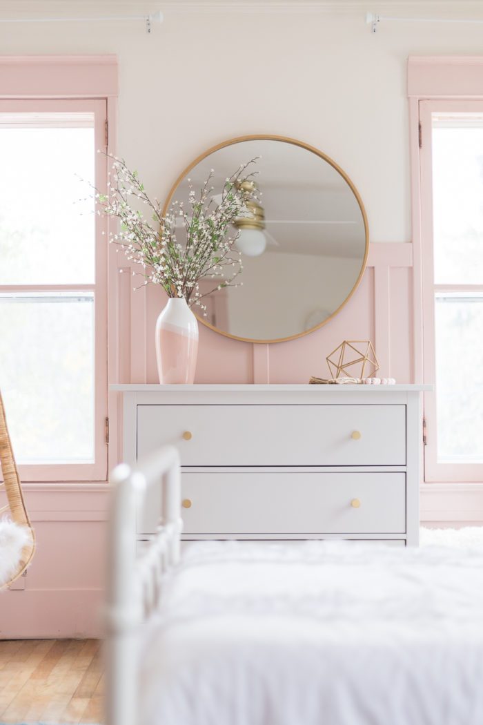 Girls Bedroom with pink board and batten, white furniture and gold accents. 