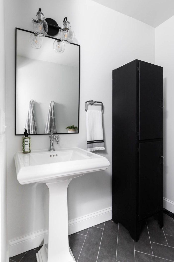 black herringbone tile in a small bathroom adds depth to design. 