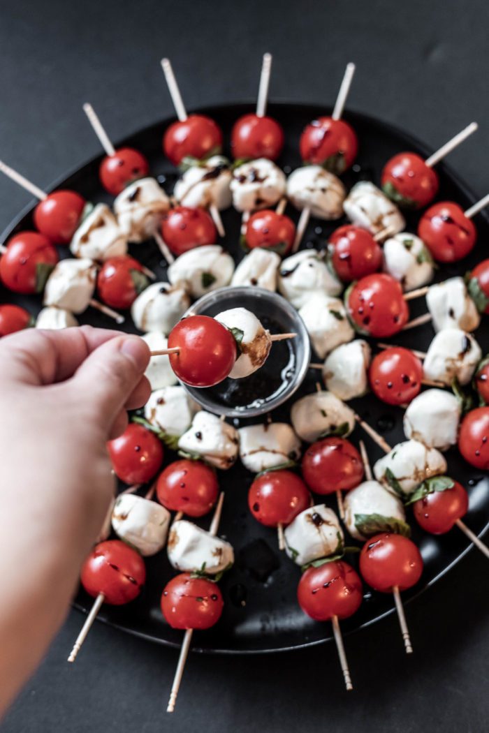 Dip caprese skewers into a balsamic reduction for a burst of flavor. 