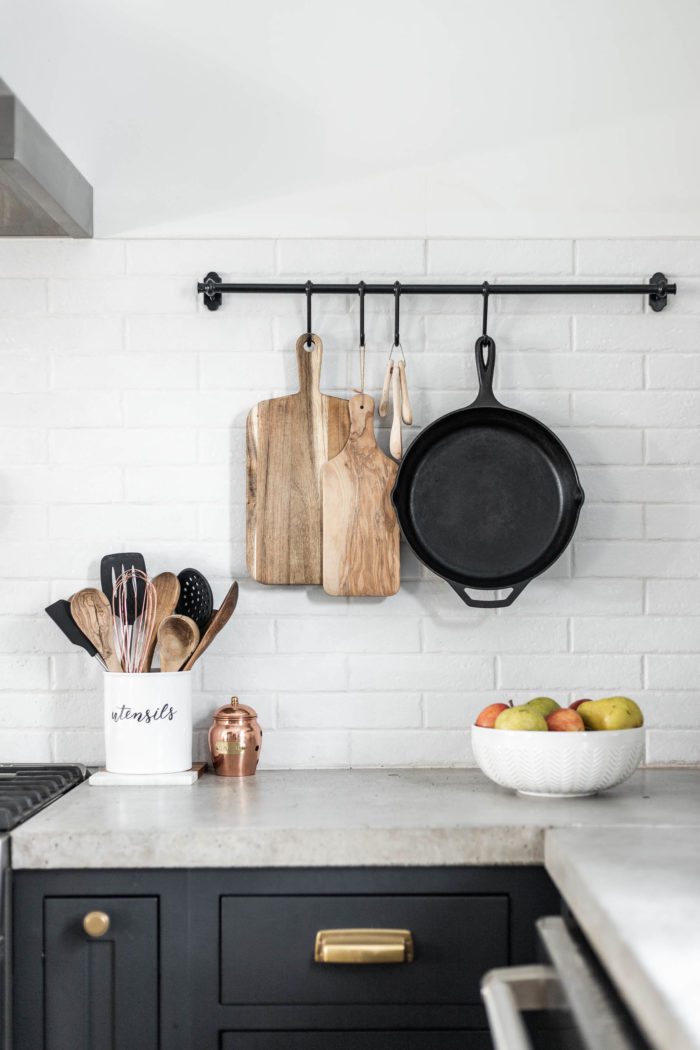 cutting board hanging on wall in kitchen with a bowl of apples and pears. Modern Rustic Christmas Home Tour