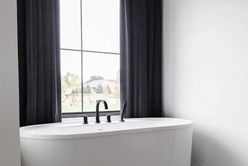 Do you have a large window in your bathroom? Don't be afraid to hang full length curtains in a bathroom as a bold accent!