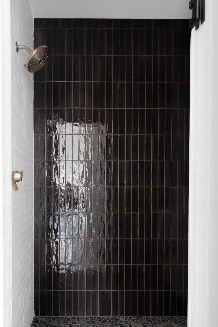 Vertically stacked black tile for an accent wall in a master shower. 