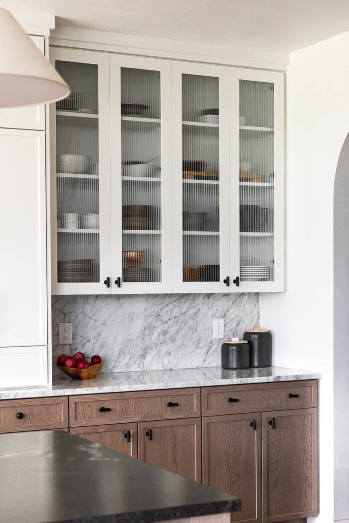 Reeded Glass Cabinets in the kitchen decorated for Fall with a Modern European look. 