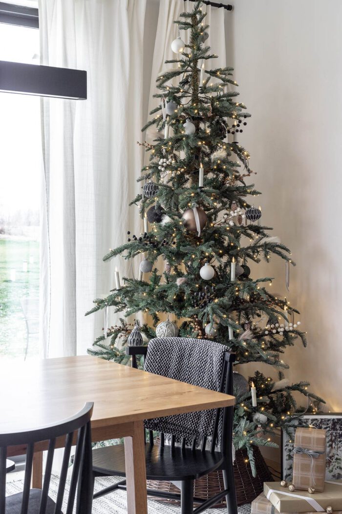 King Noble Fir Christmas Tree from King of Christmas decorated with neutral ornaments and a modern European style. 