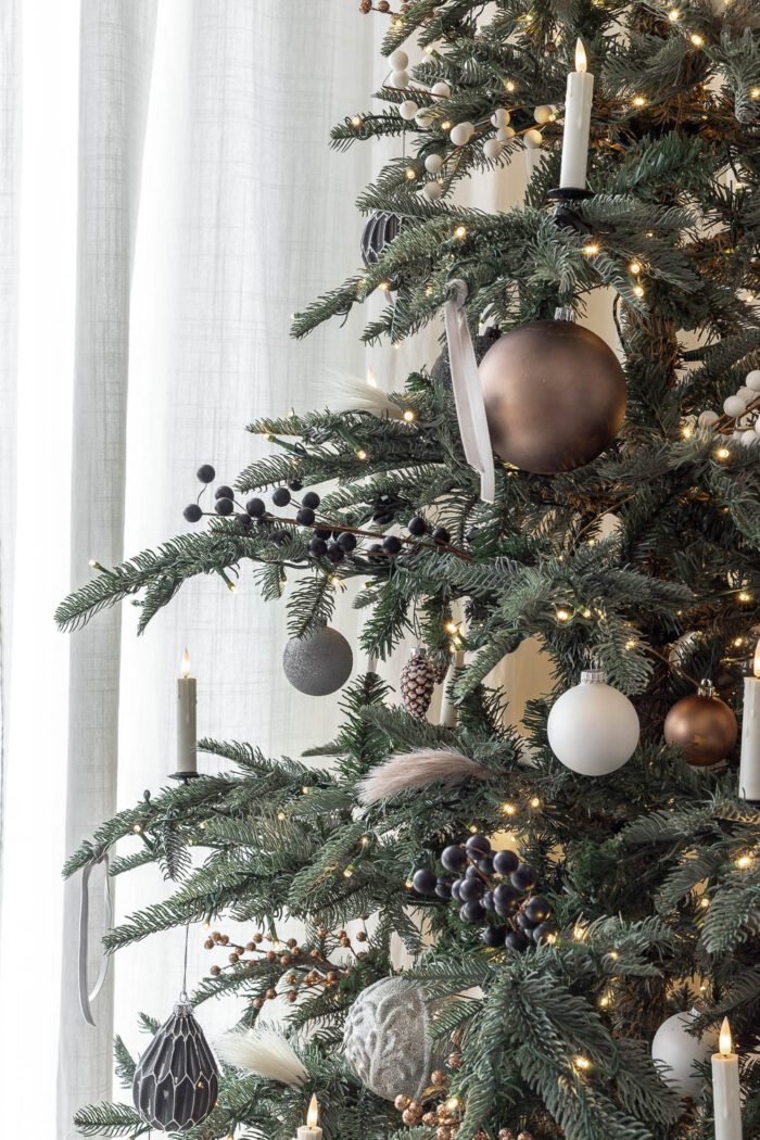 Neutral Ornaments on a noble fir tree in the dining room. 